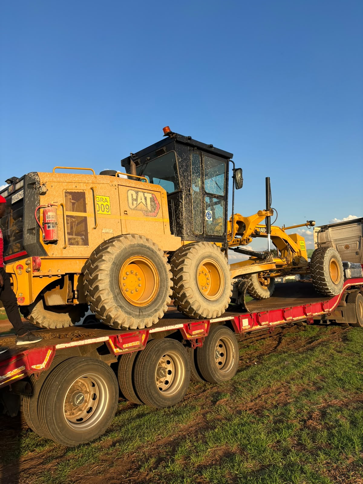 Grader being delivered on a lowbed trailer